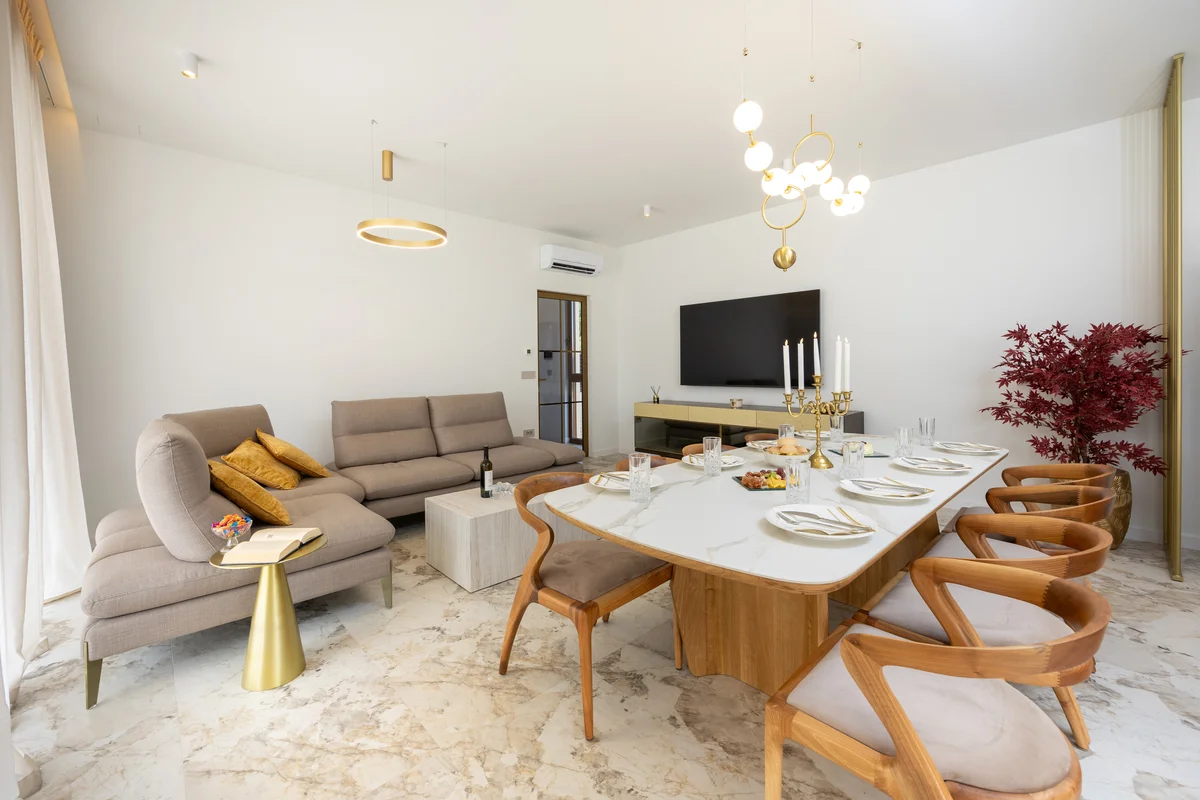 a living room with a table and chairs