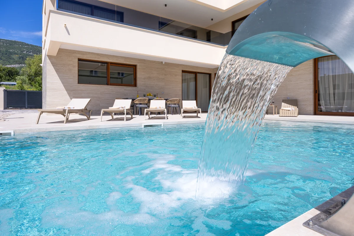 a swimming pool with a large building in the background