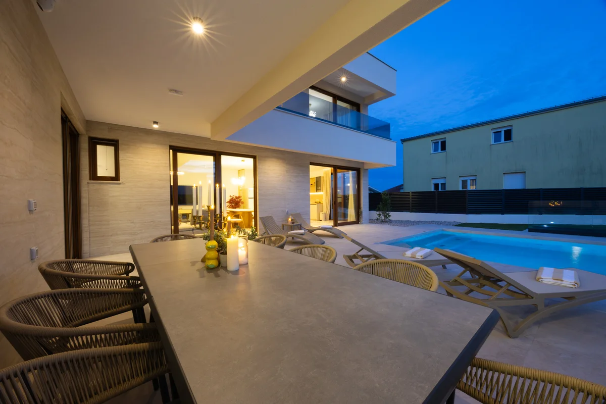 a large room with a table and chairs and a pool